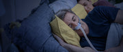Man sleeping peacefully wearing an AirFit N30 nasal cradle CPAP mask