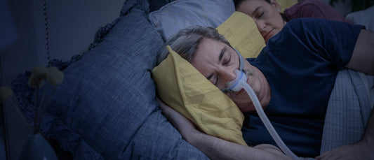 Man sleeping peacefully wearing an AirFit N30 nasal cradle CPAP mask