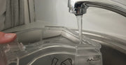 Person washing and maintaining a CPAP water chamber