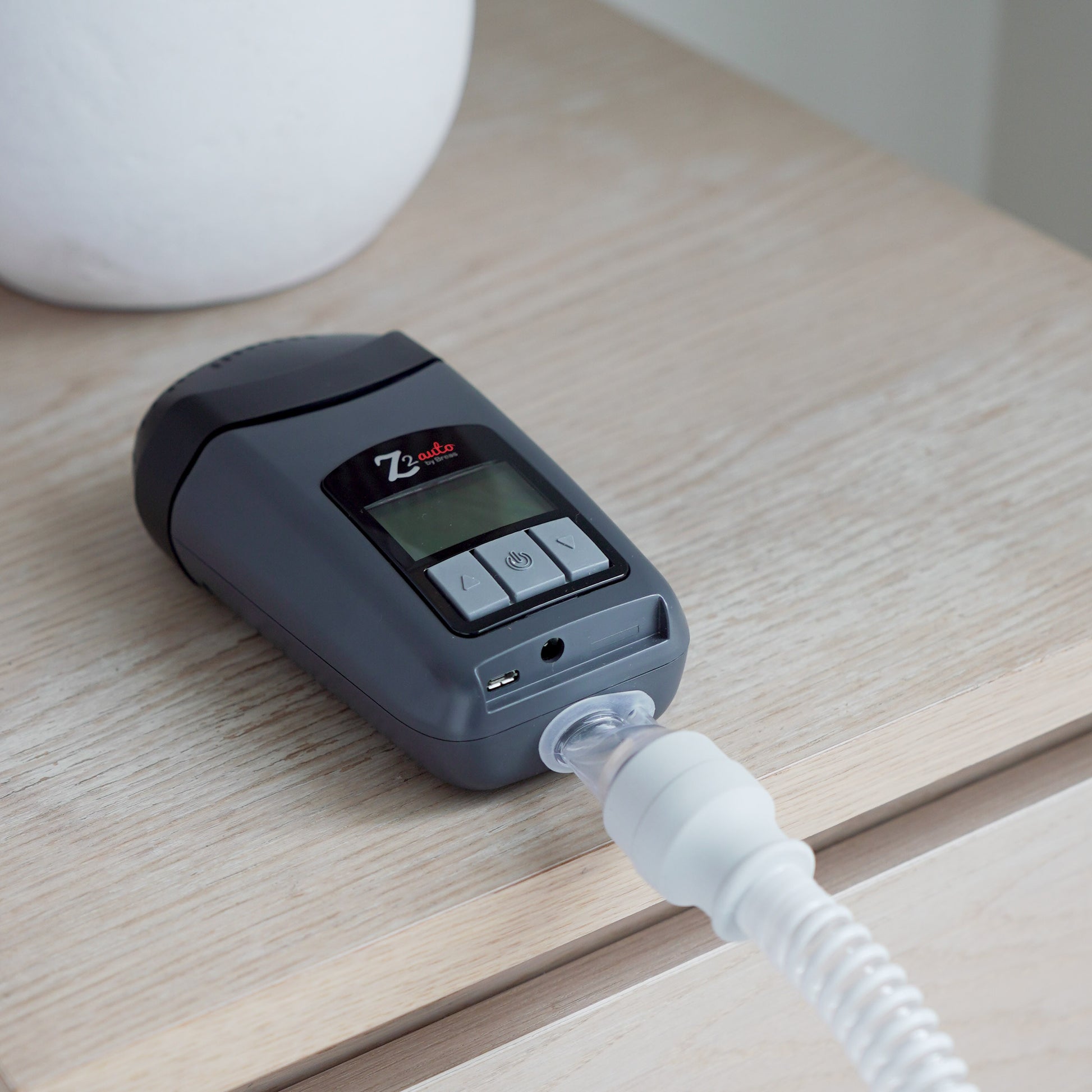 The Breas Z2 placed on a bedside table showing its small form factor