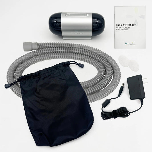 React Health Luna TravelPAP Auto CPAP machine with tubing, carrying pouch, power adapter, user manual, and replacement filters displayed on a white background