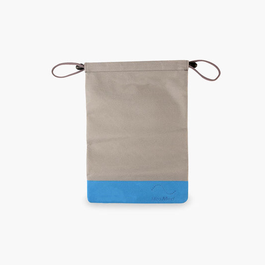 ResMed AirMini™ Travel CPAP Drawstring Storage Bag on grey background.