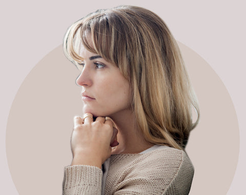 Side profile of a woman contemplating if her symptoms are sleep apnea related.