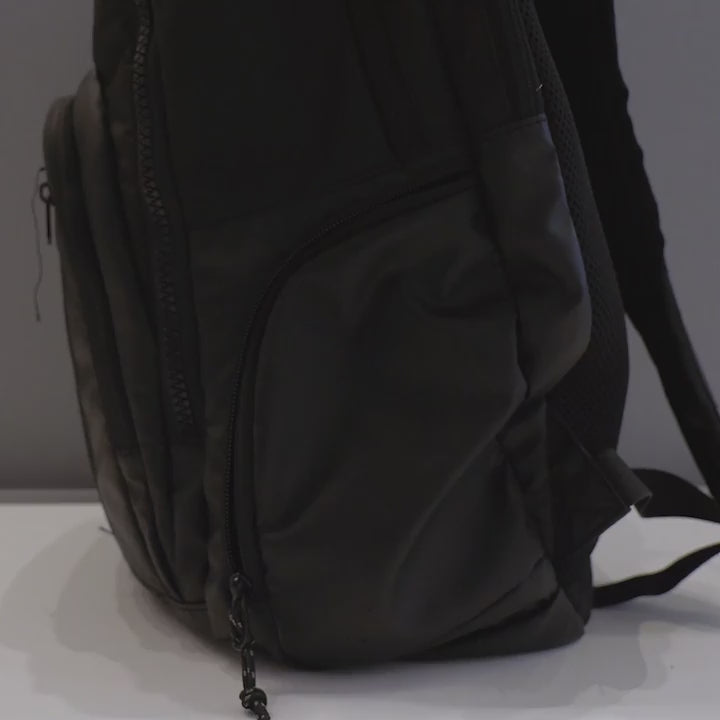 Video of a person packing the ResMed AirMini into a side pocket of a laptop backpack. 