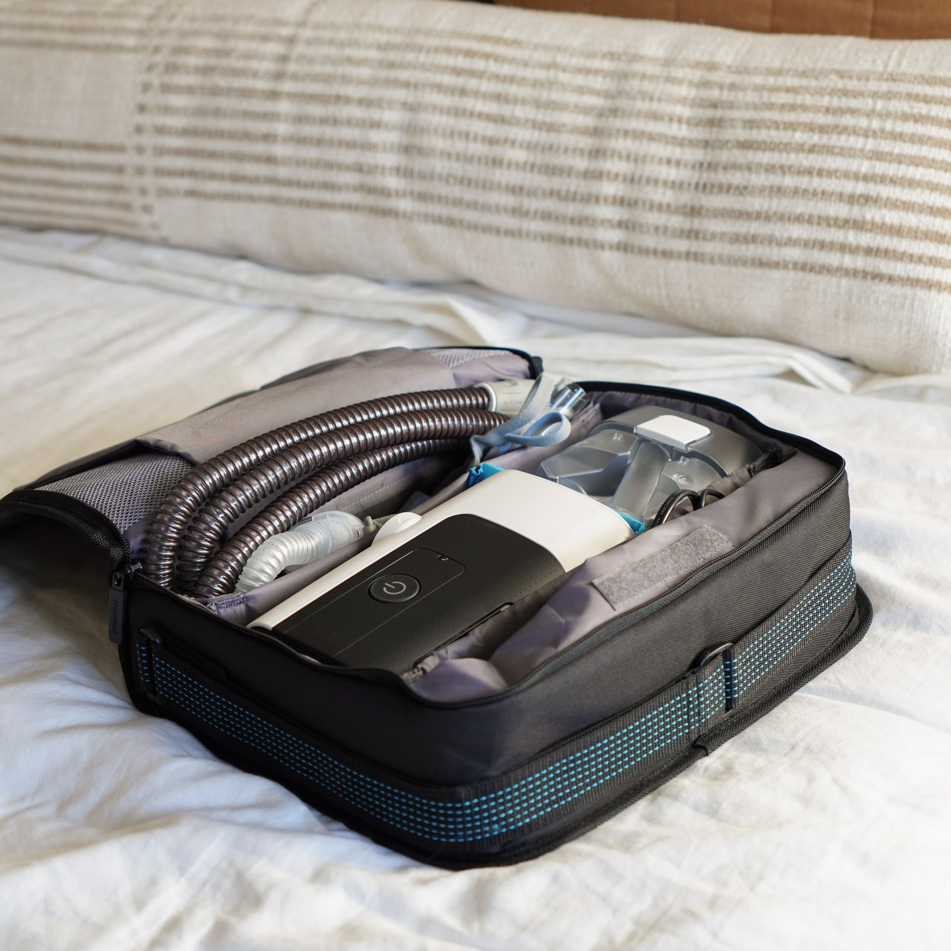 AirSense 11 packed in a travel suitcase, showing portability and small form factor